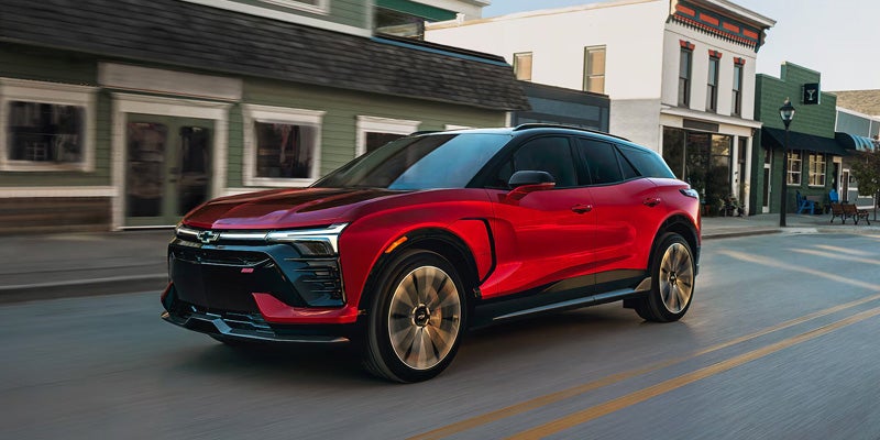 Red Chevrolet SUV driving on a city street