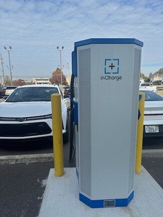 Rear-side view of an InCharge electric vehicle charging station located in a parking lot